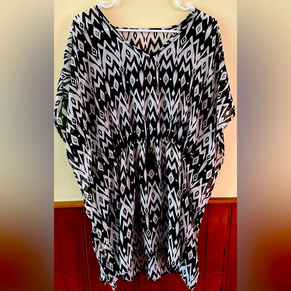 Swimsuit coverup. One size fits “most”. V 100% polyester.